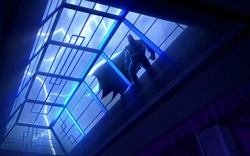 An animated low-angle shot looking up through an angular glass skylight, with lightning flashing across a stormy blue sky. Batman stands in silhouette on a ledge at the upper right, his cape draped behind him. The skylight has an art deco geometric frame, and the whole scene is bathed in deep blue and purple.