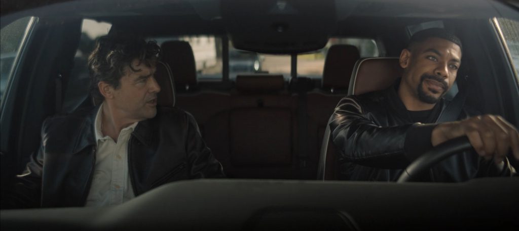 Hal Jordan and John Stewart sitting in a car and talking in Lanterns.