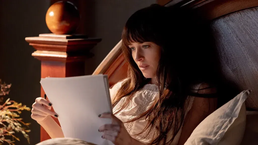 Dakota Johnson reads a manuscript
