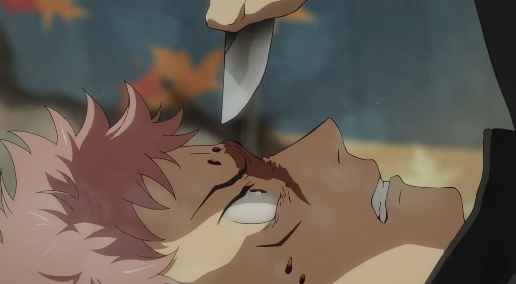 The image shows a scene featuring the character Yuji Itadori lying down with a knife pointed near his face, from a teaser or promotional material for Jujutsu Kaisen.