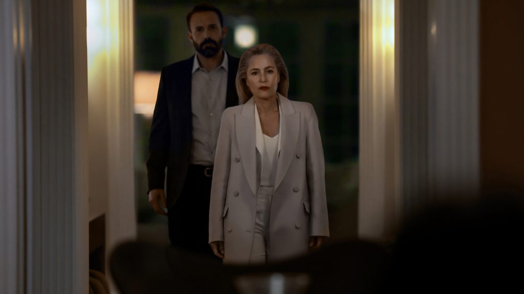 Ben Affleck and Gillian Anderson walk in a dark hallway
