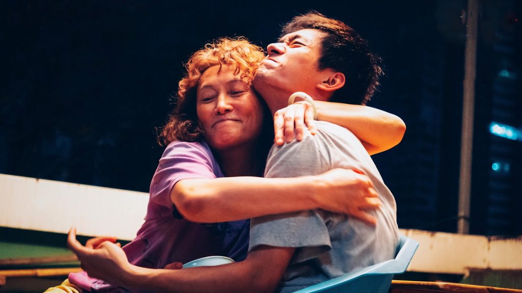 A man and a woman hugging in Big World, available to stream on Netflix.