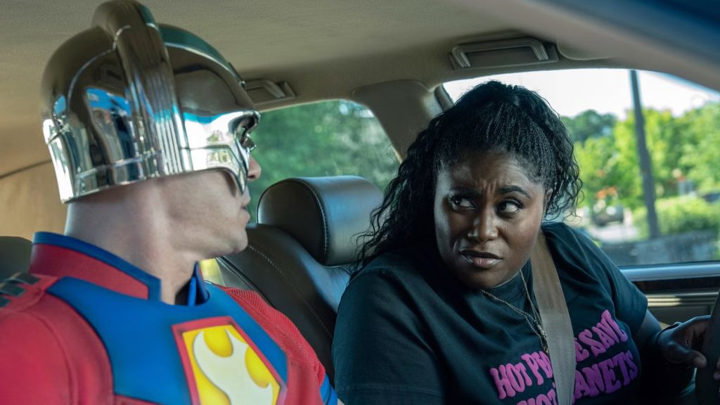 Peacemaker and Leota Adebayo in a car in a still from James Gunn's Peacemaker.